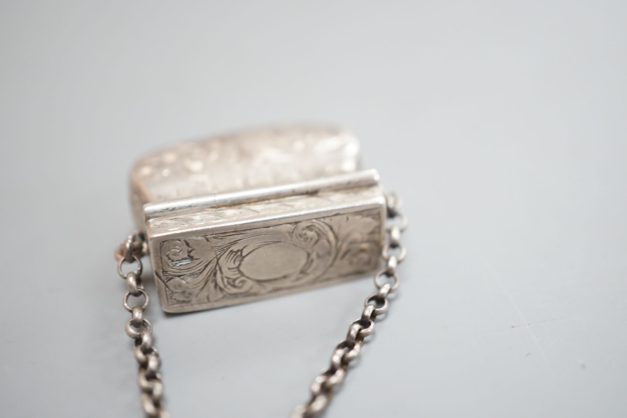 A Victorian novelty silver vinaigrette, modelled as a handbag, John Tongue, Birmingham, circa, 1840 (date letter rubbed), width 27mm.